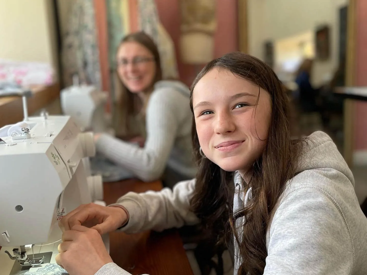 Child parent at sewing machines